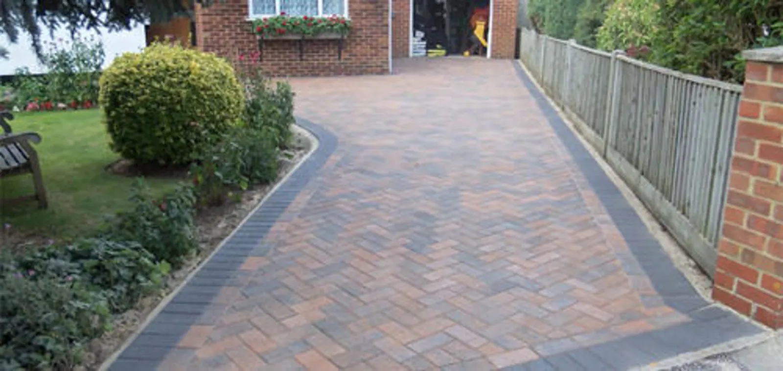 Completed block-paved driveway with a contrasting charcoal edge